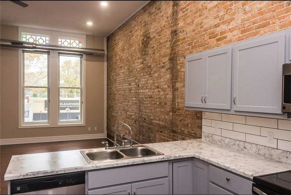 Exposed-brick apartment interior from Gemini’s existing website