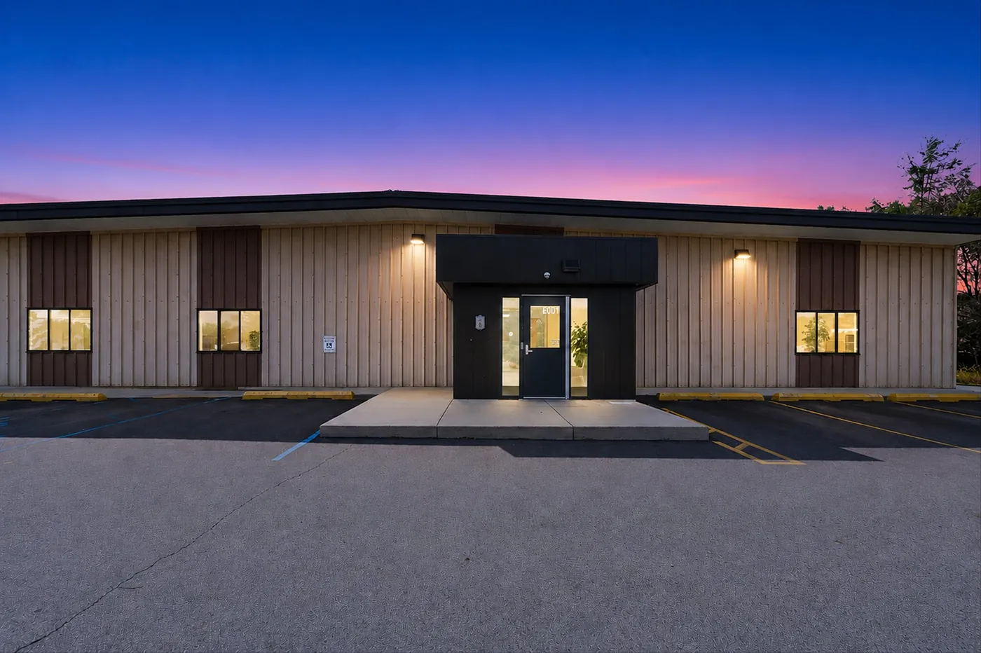 Illuminated commercial building entrance at twilight